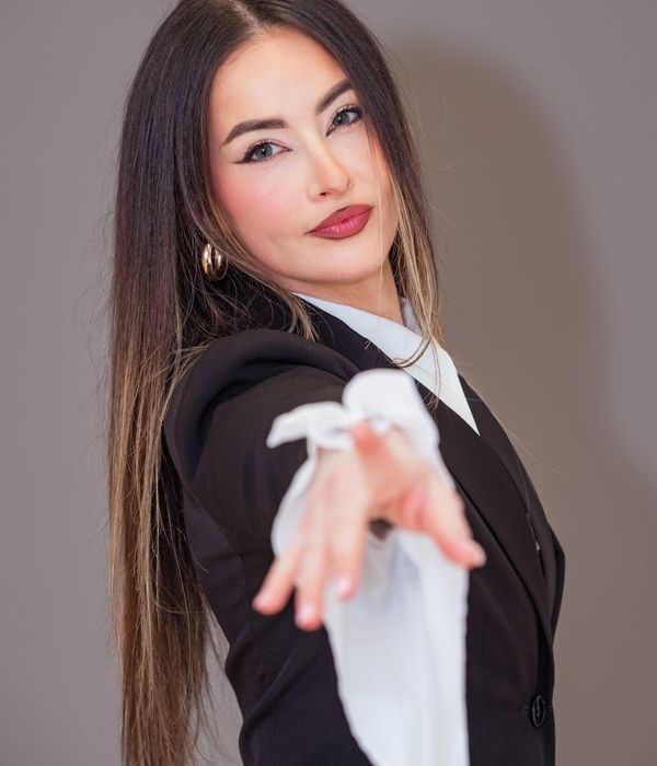 Professional woman in business attire with warm smile
